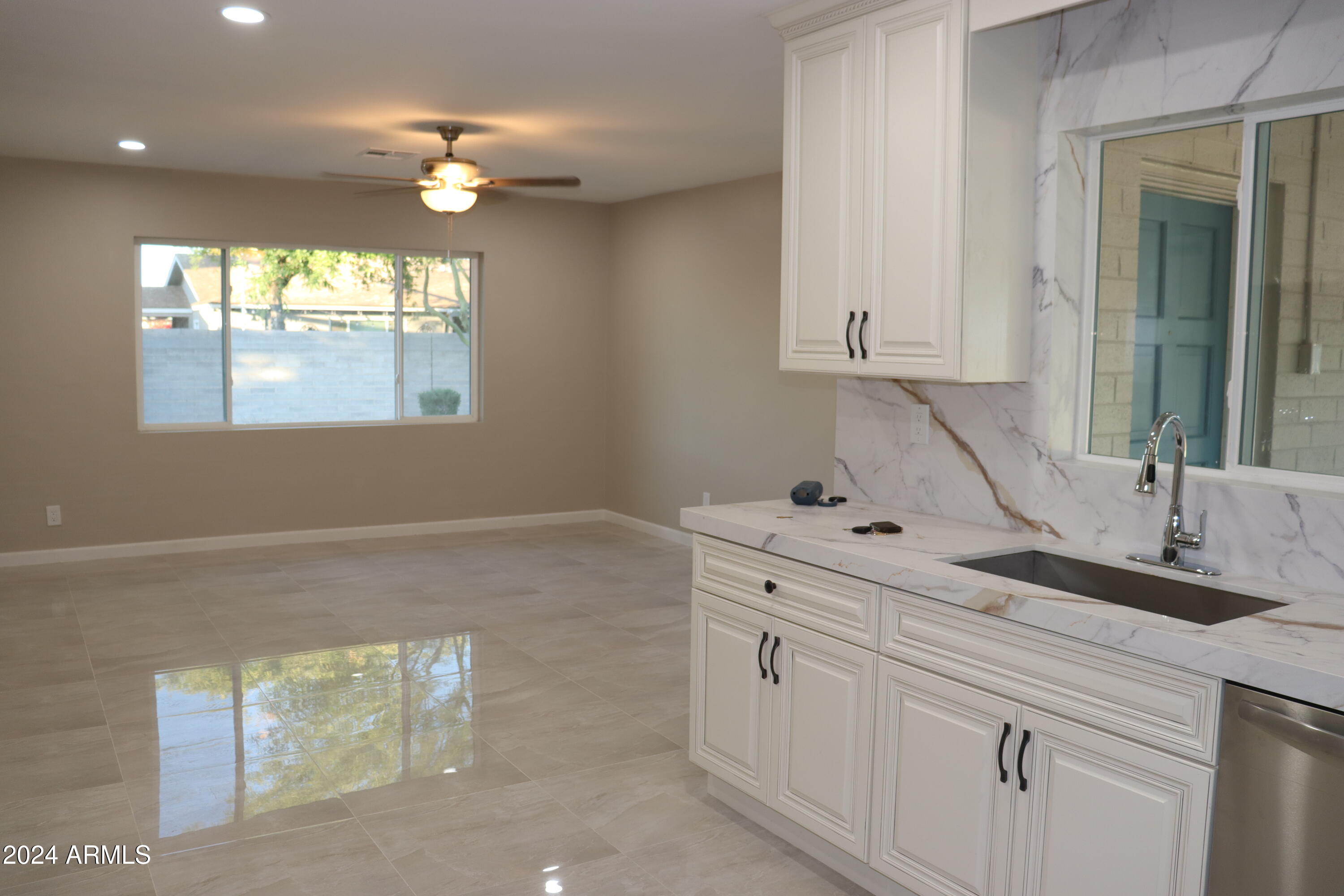 6702 East Almeria Road Scottsdale, AZ 85257 - Photo 6 of 23 a kitchen with white cabinets and window