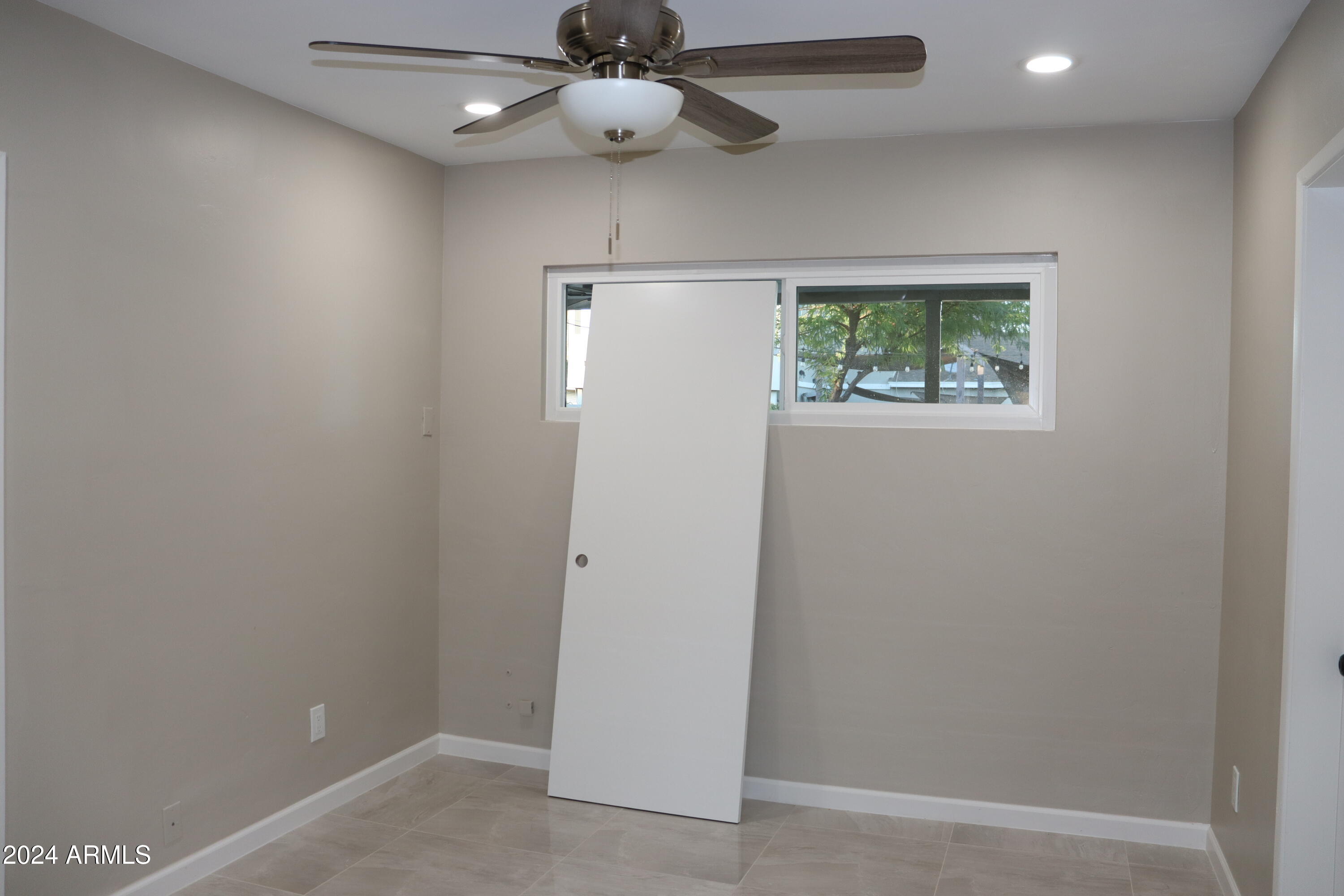 6702 East Almeria Road Scottsdale, AZ 85257 - Photo 10 of 23 an empty room with windows and ceiling fan