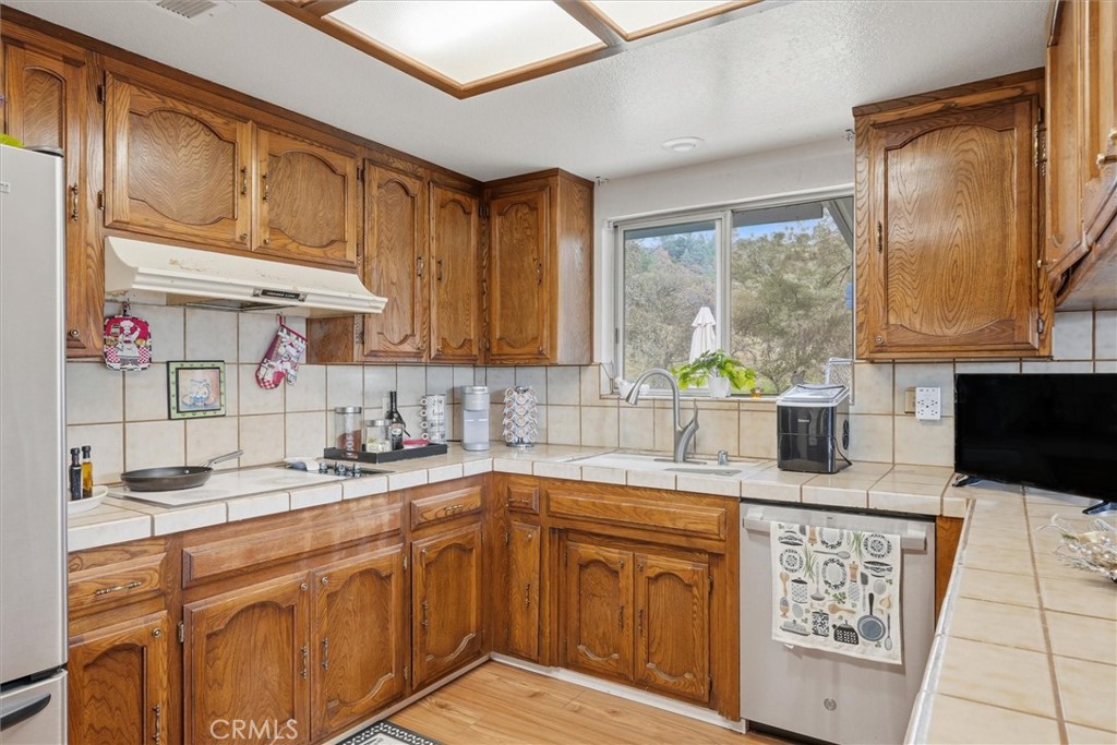 5060-5064 Mykleoaks Road Mariposa, CA 95338 - Photo 12 of 63 a kitchen with stainless steel appliances granite countertop a sink stove and cabinets