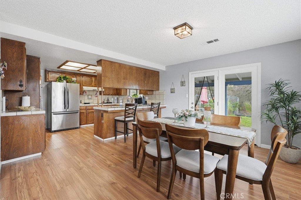 5060-5064 Mykleoaks Road Mariposa, CA 95338 - Photo 15 of 63 a dining room with stainless steel appliances a table and chairs