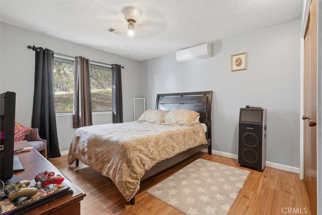 5060-5064 Mykleoaks Road Mariposa, CA 95338 - Photo 18 of 63 a bedroom with a bed and large windows