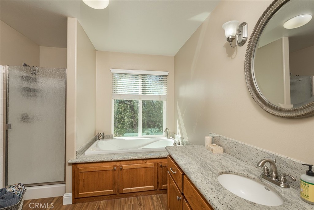 5060-5064 Mykleoaks Road Mariposa, CA 95338 - Photo 58 of 63 a bathroom with a granite countertop sink and a mirror