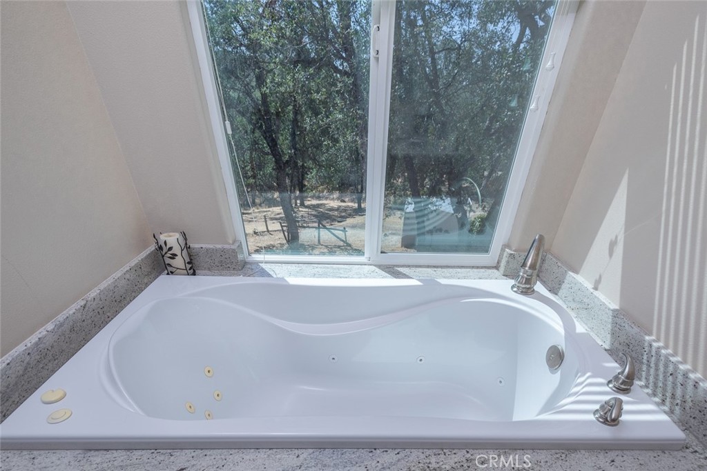 5060-5064 Mykleoaks Road Mariposa, CA 95338 - Photo 59 of 63 a bath tub sitting in a bathroom next to a window