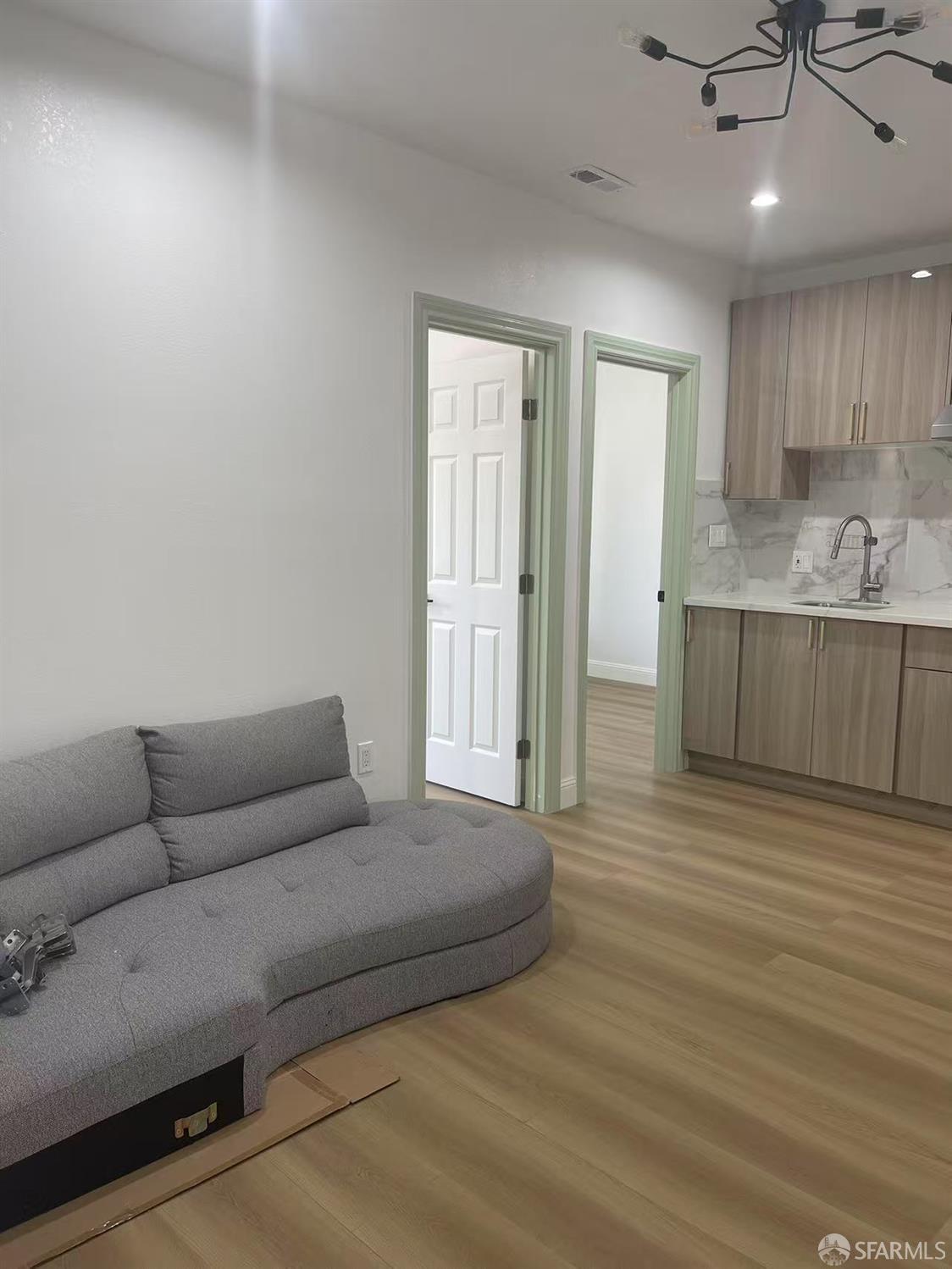 1435 Newcomb Avenue San Francisco, CA 94124 - Photo 2 of 9 a living room with furniture and a wooden floor