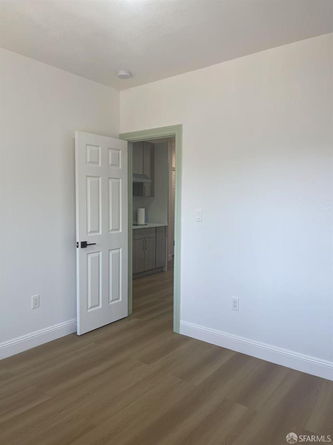 1435 Newcomb Avenue San Francisco, CA 94124 - Photo 5 of 9 an empty room with wooden floor & closet area