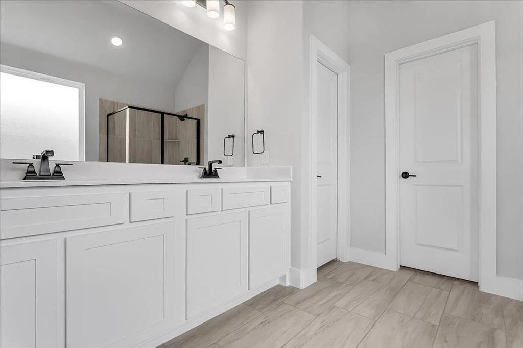 6246 Shasta Creek Road Celina, TX 75009 - Photo 14 of 24 a bathroom with a double vanity sink and a mirror