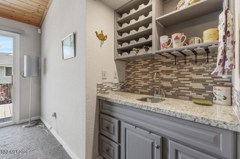 675 College Drive Reno, NV 89503 - Photo 15 of 30 a bathroom with a granite countertop sink and a mirror
