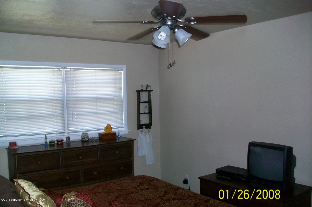 4412 South Bonham Street Amarillo, TX 79110 - Photo 12 of 26 a bed room with a bed and a window