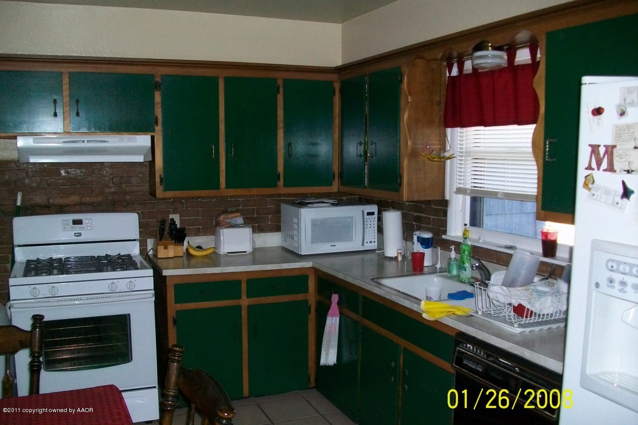 4412 South Bonham Street Amarillo, TX 79110 - Photo 18 of 26 a kitchen with a sink cabinets and window