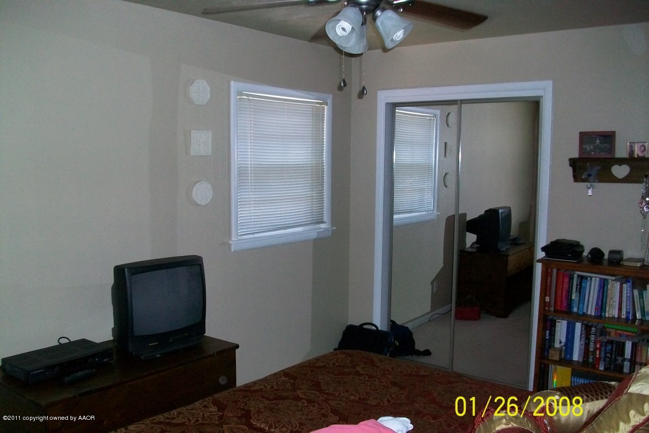 4412 South Bonham Street Amarillo, TX 79110 - Photo 21 of 26 a bedroom with a bed and a book shelf