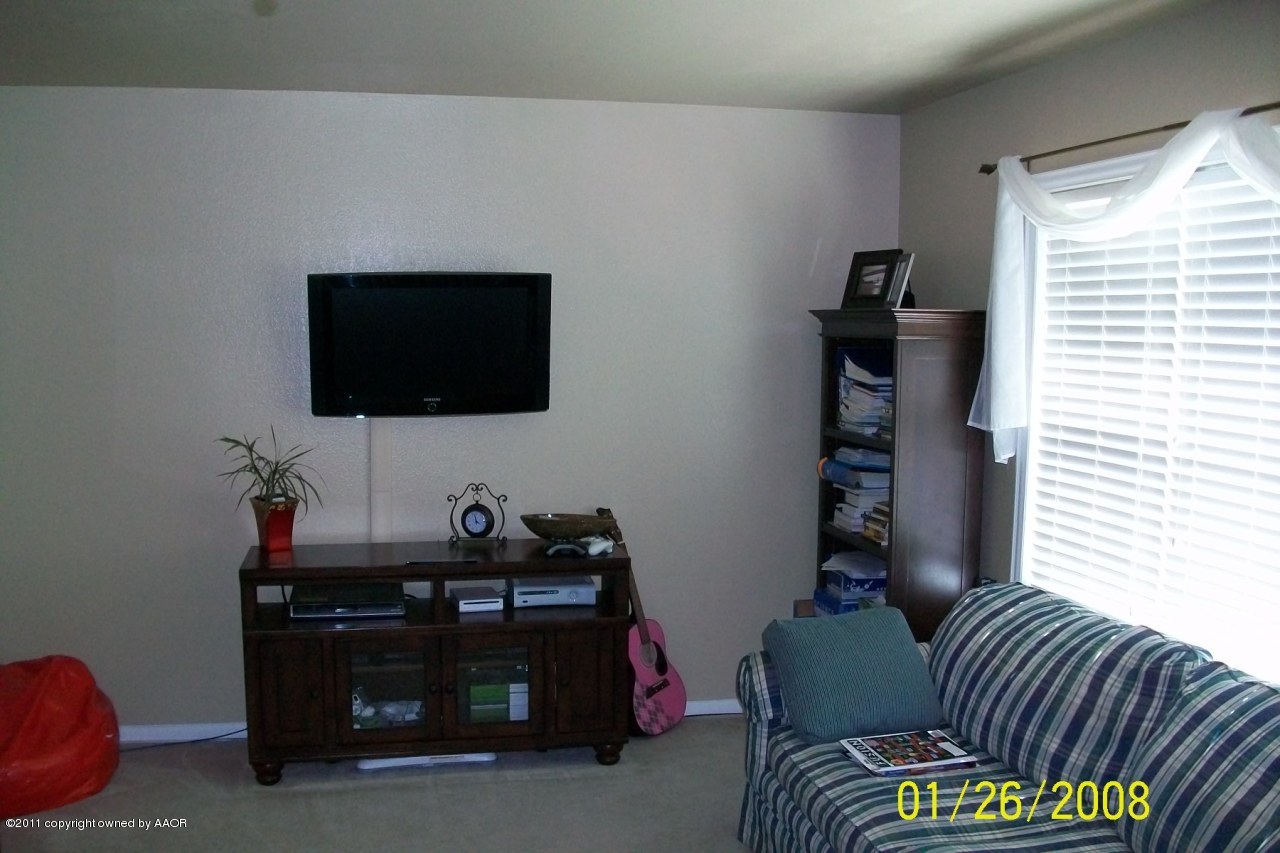 4412 South Bonham Street Amarillo, TX 79110 - Photo 26 of 26 a living room with furniture and a flat screen tv
