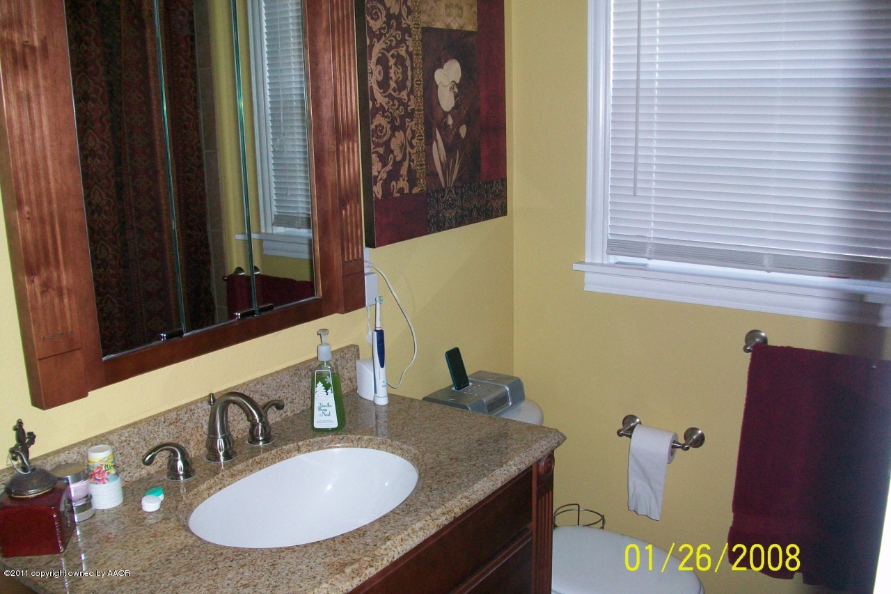 4412 South Bonham Street Amarillo, TX 79110 - Photo 9 of 26 a bathroom with a granite countertop sink and a mirror
