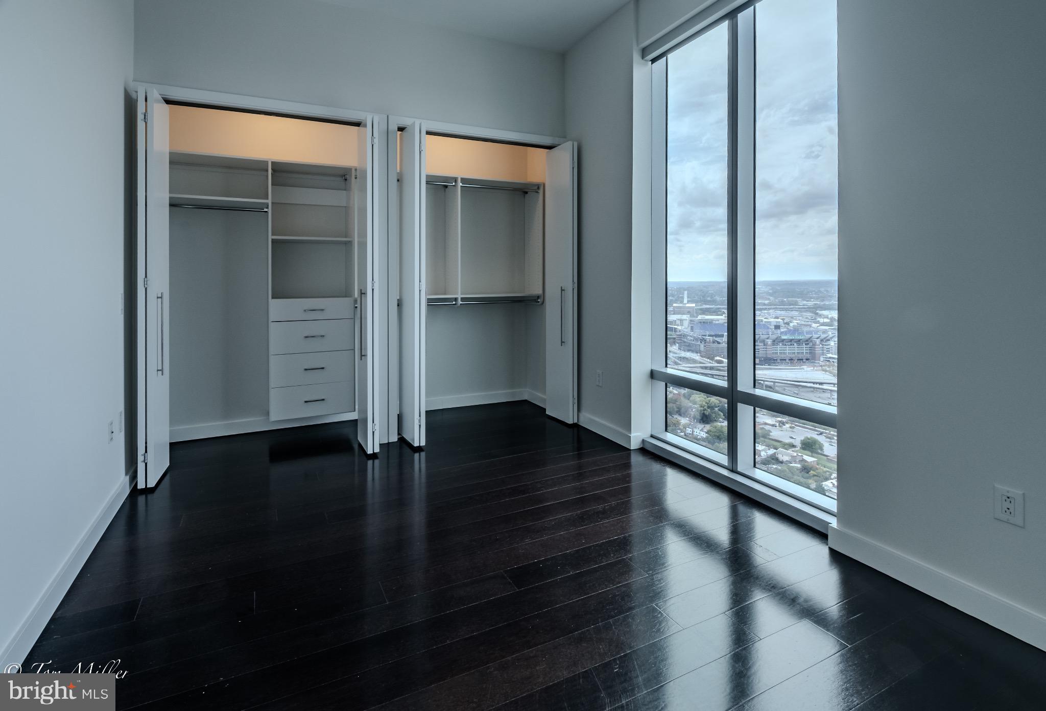 414 Light Street, Unit 4302 Baltimore, MD 21202 - Photo 15 of 42 an empty room with wooden floor closet and windows