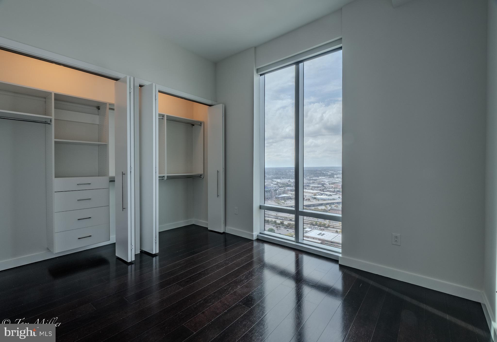 414 Light Street, Unit 4302 Baltimore, MD 21202 - Photo 16 of 42 wooden floor in an empty room with a window