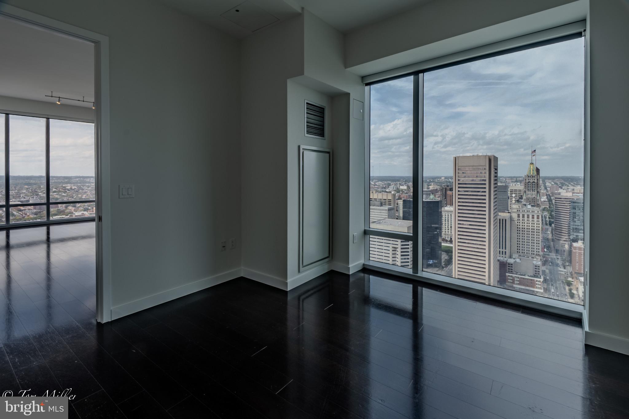 414 Light Street, Unit 4302 Baltimore, MD 21202 - Photo 22 of 42 a view of empty room with wooden floor and fan