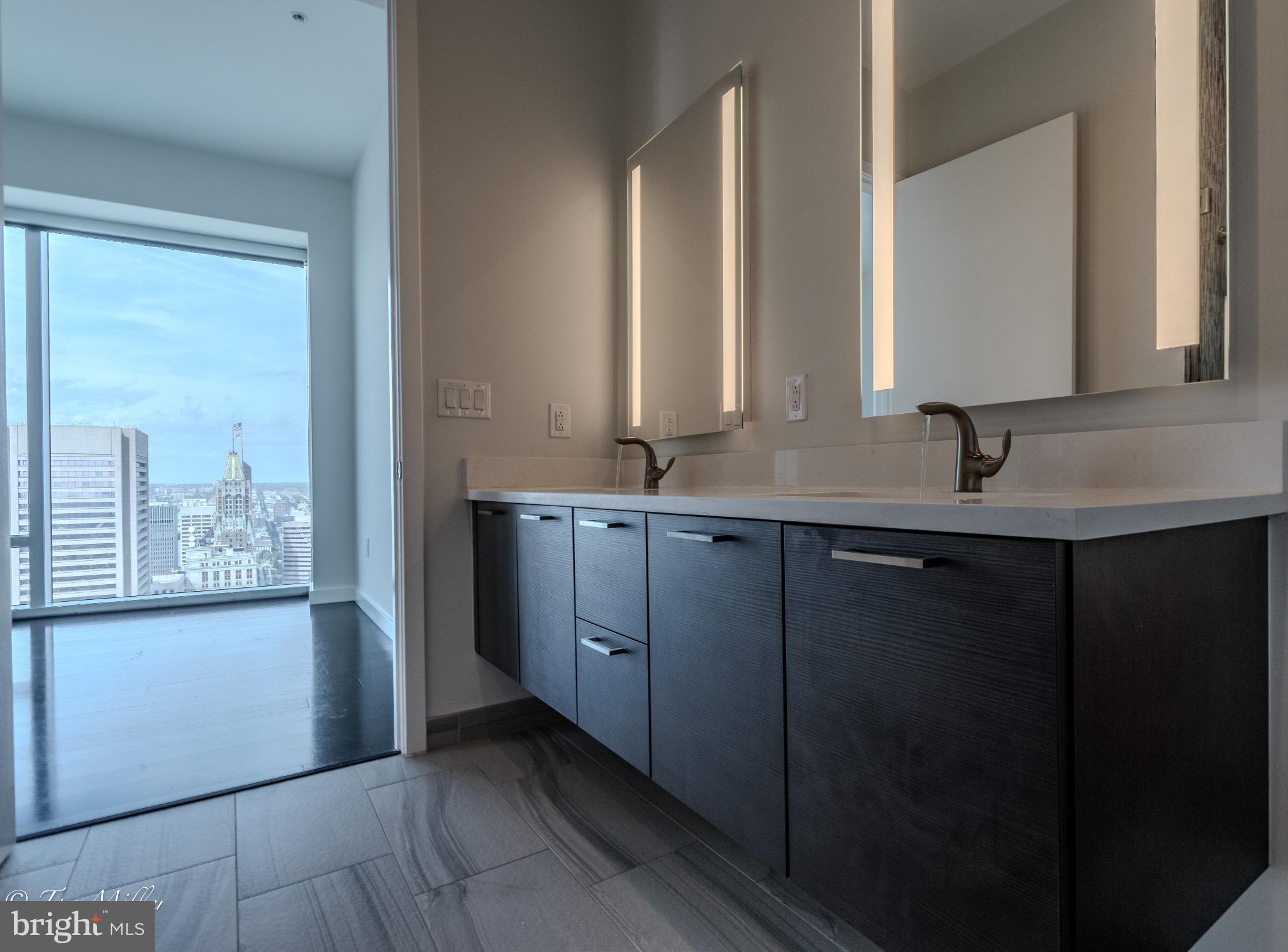 414 Light Street, Unit 4302 Baltimore, MD 21202 - Photo 27 of 42 a bathroom with a double vanity sink and a mirror