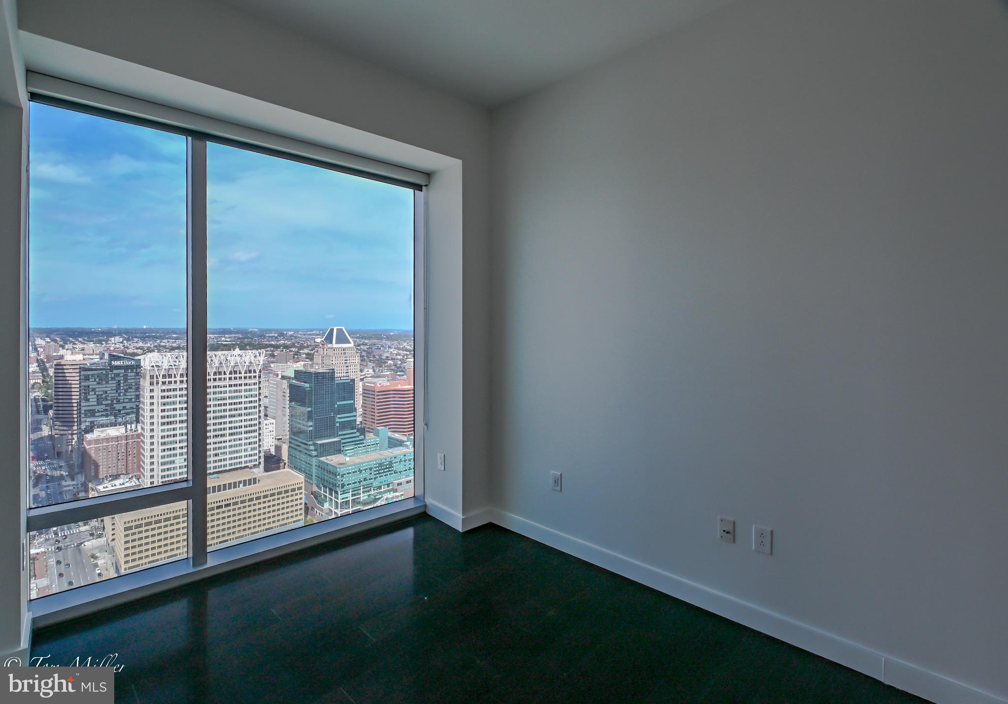 414 Light Street, Unit 4302 Baltimore, MD 21202 - Photo 31 of 42 a view of an empty room with wooden floor and a window