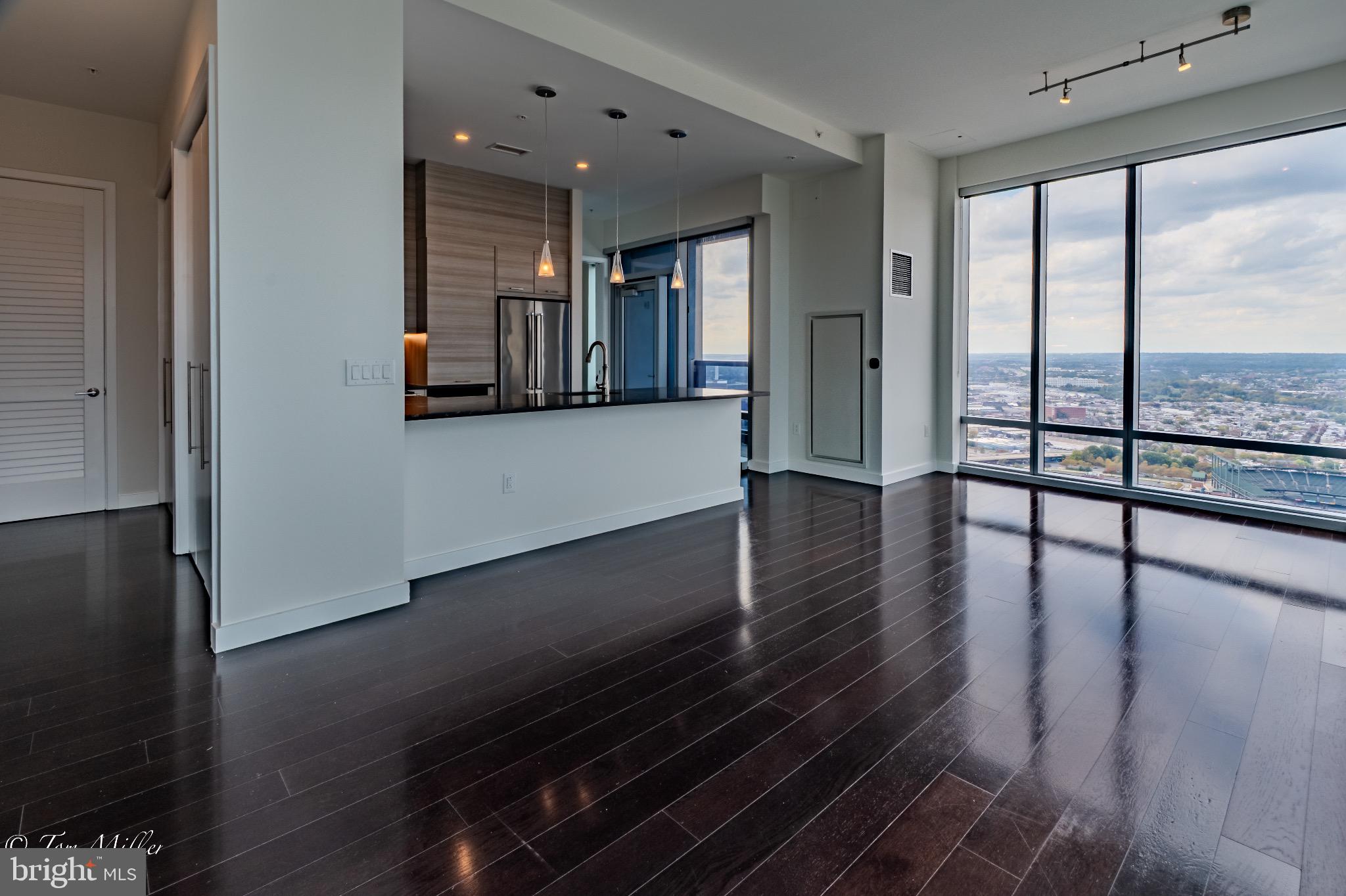 414 Light Street, Unit 4302 Baltimore, MD 21202 - Photo 4 of 42 an empty room with wooden floor and windows