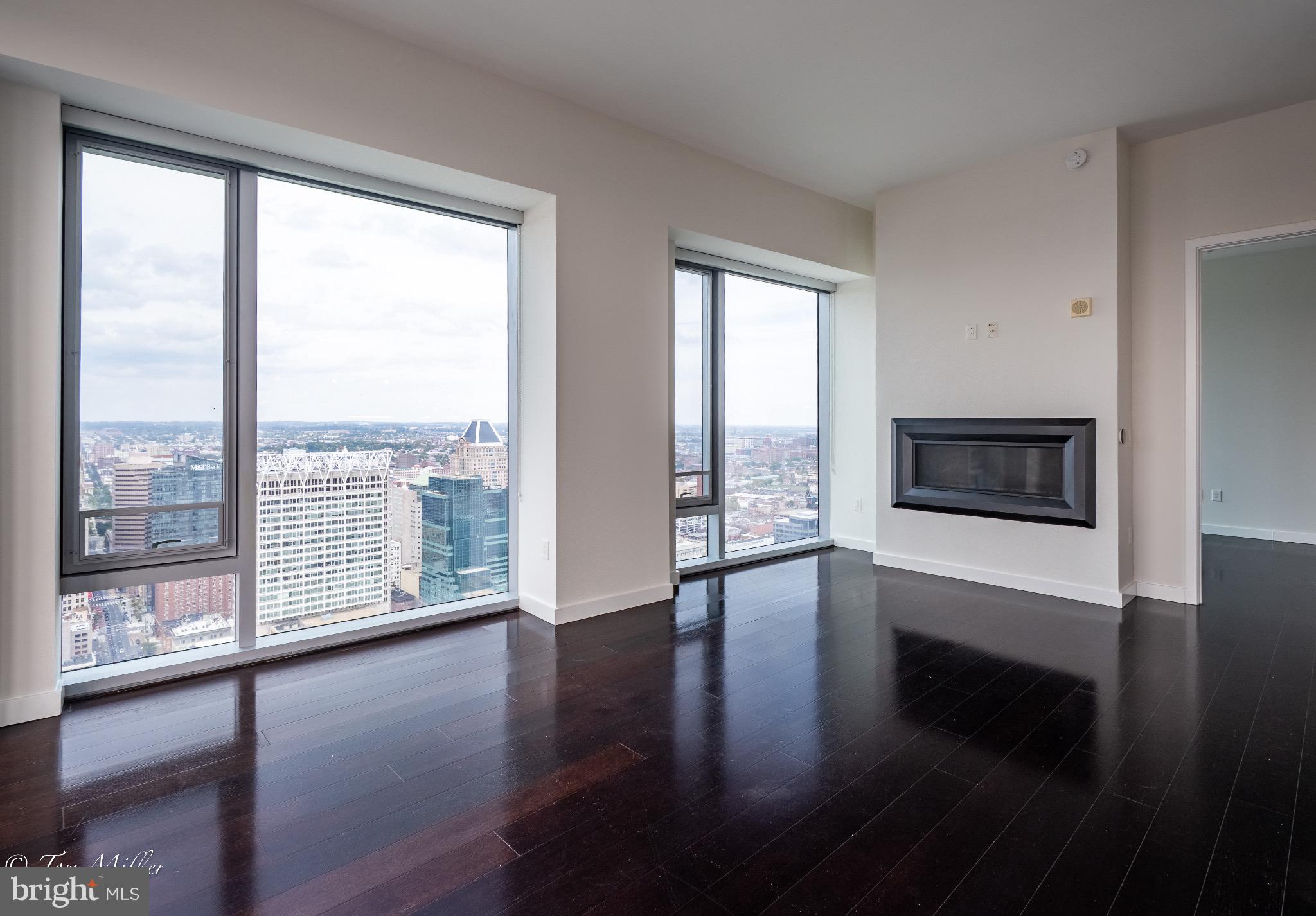 414 Light Street, Unit 4302 Baltimore, MD 21202 - Photo 7 of 42 a view of an empty room with wooden floor and a window