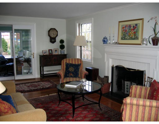 47 Crown Ridge Road Wellesley, MA 02482 - Photo 3 of 11 a living room with furniture a clock and a fireplace