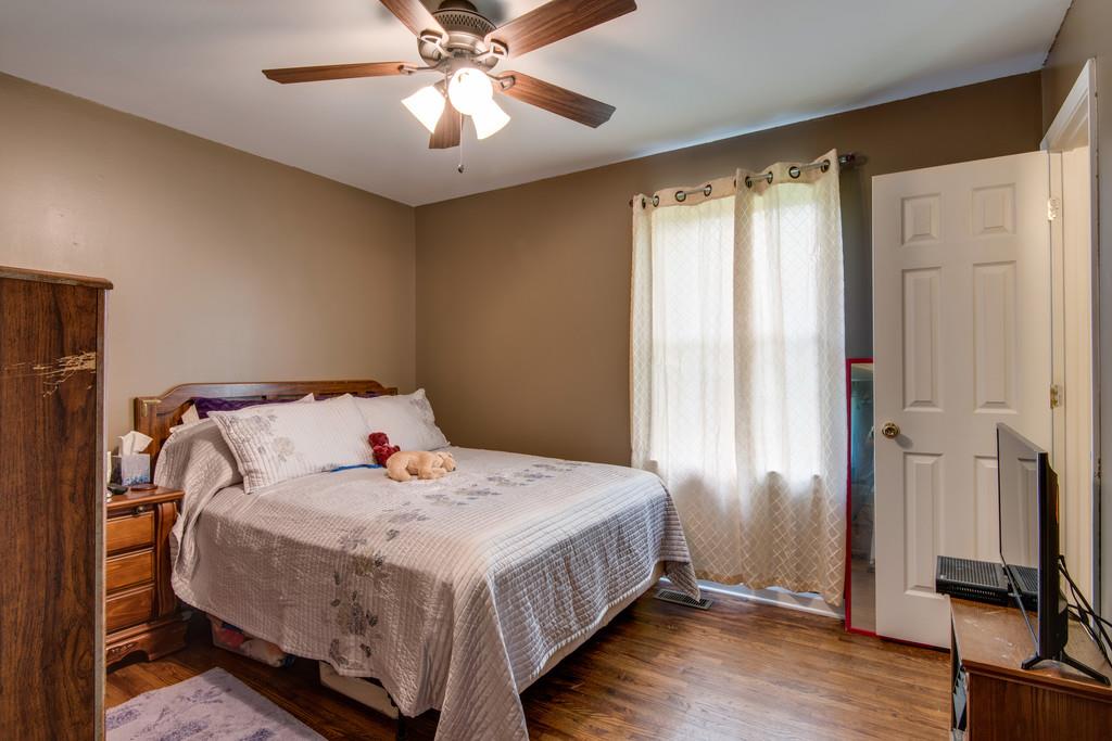 120 Mae Circle Dickson, TN 37055 - Photo 13 of 19 a bedroom with a bed and a chandelier