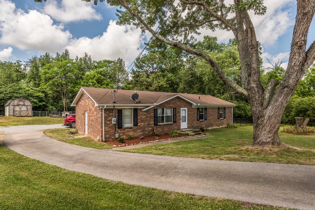 120 Mae Circle Dickson, TN 37055 - Photo 2 of 19 a view of a house with a big yard and large trees