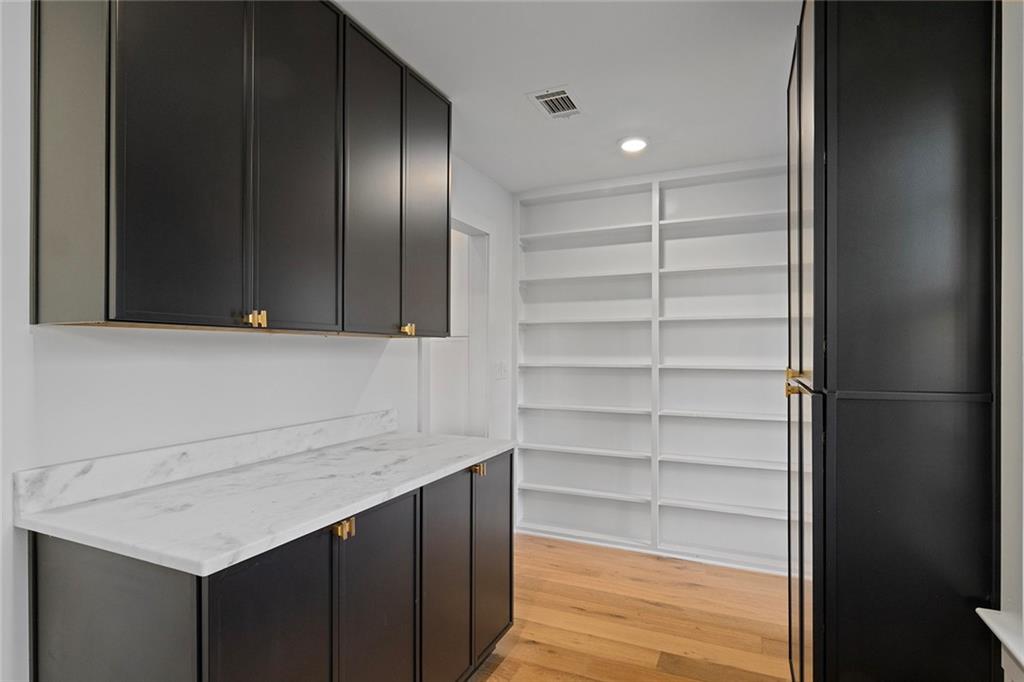 1275 The By Way Northeast Atlanta, GA 30306 - Photo 17 of 48 a view of kitchen with white cabinets and wooden floor