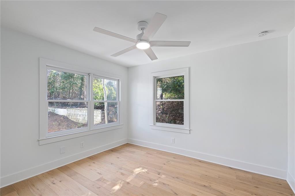 1275 The By Way Northeast Atlanta, GA 30306 - Photo 32 of 48 a view of an empty room with a window and wooden floor