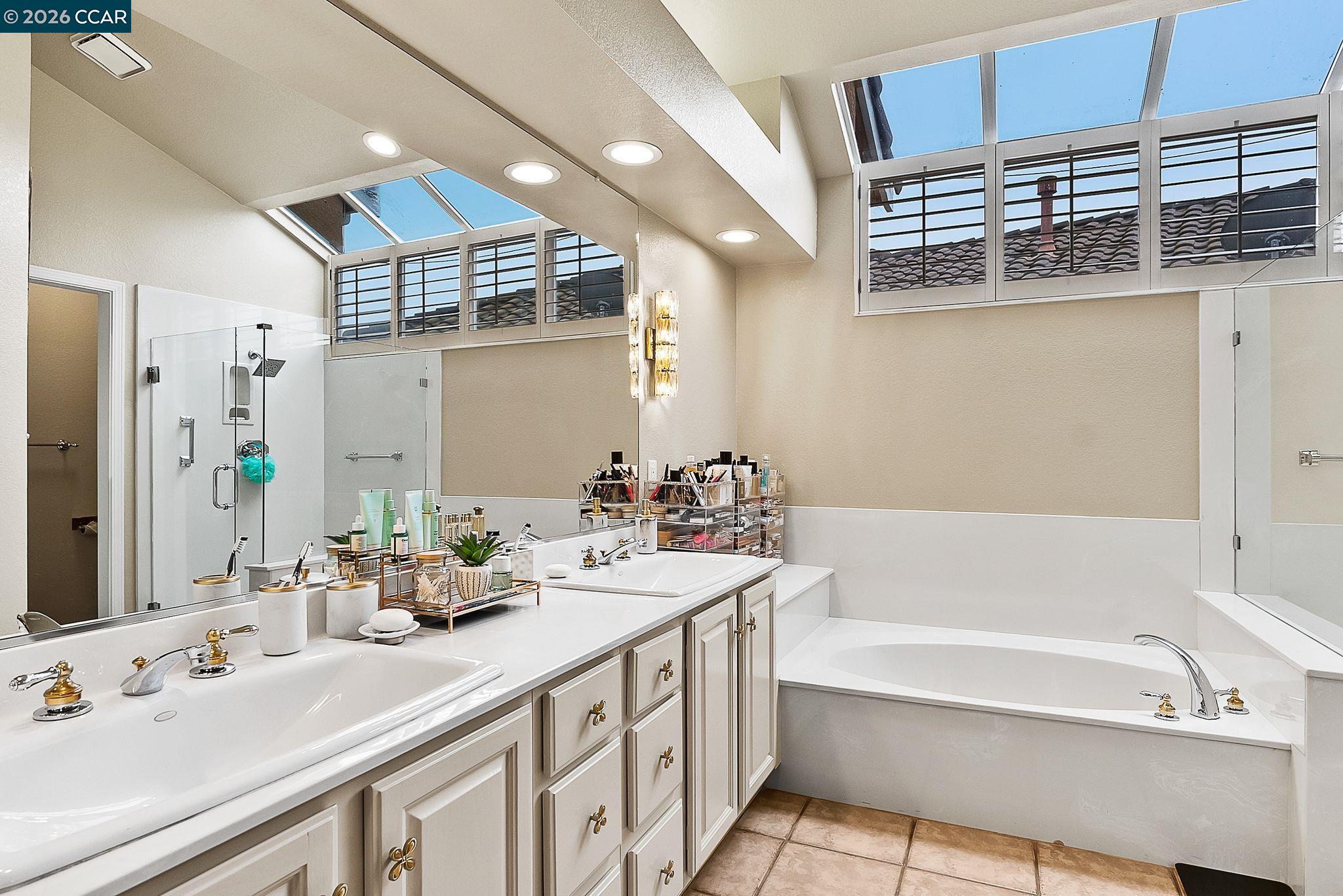 3607 Crystal Tree Court Stockton, CA 95219 - Photo 26 of 44 a bathroom with a tub sink and mirror
