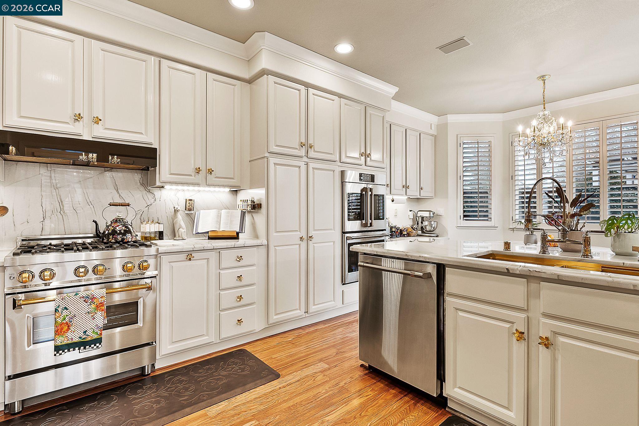 3607 Crystal Tree Court Stockton, CA 95219 - Photo 3 of 44 a kitchen with white cabinets and white appliances