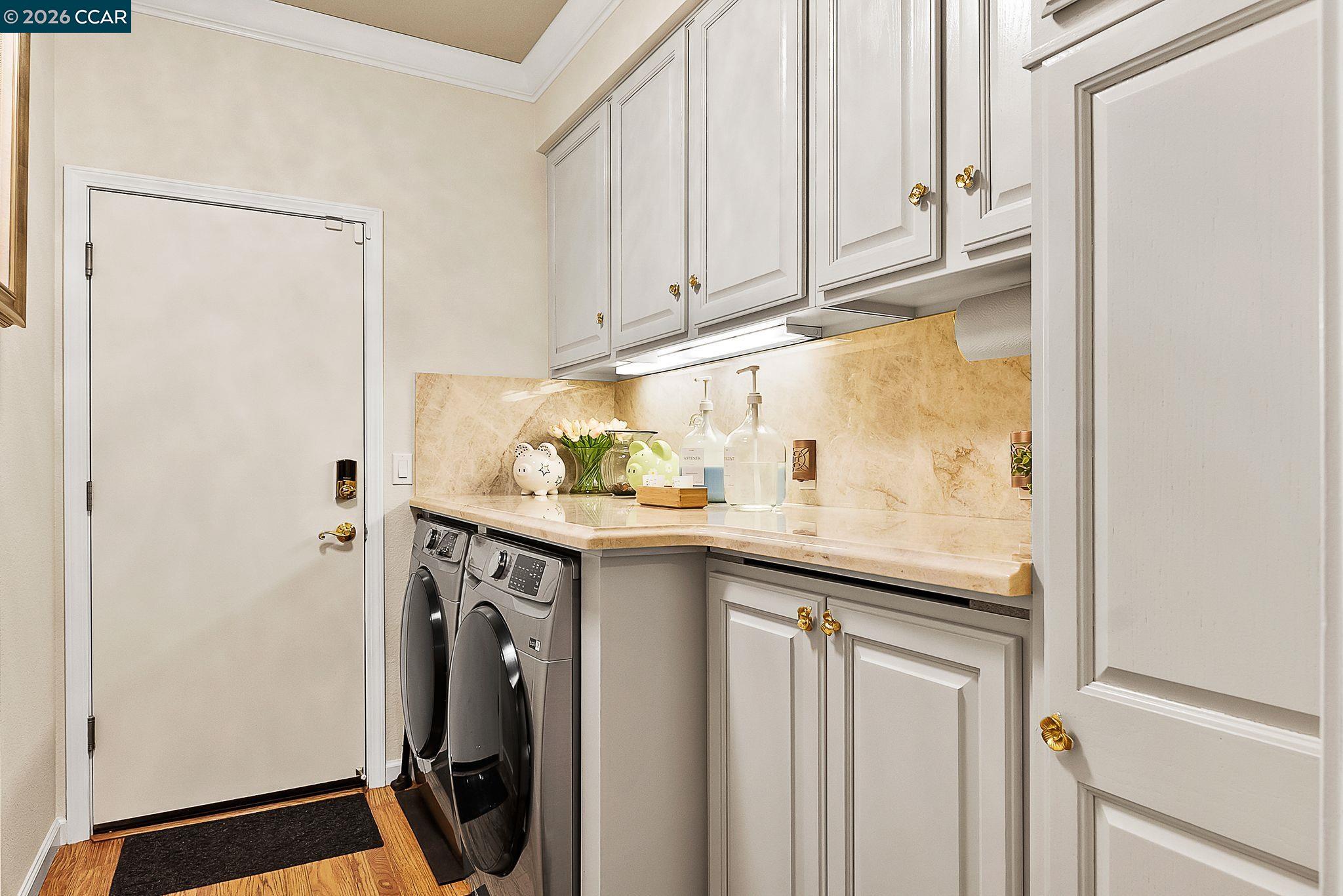 3607 Crystal Tree Court Stockton, CA 95219 - Photo 35 of 44 a utility room with granite countertop a sink a washer and dryer