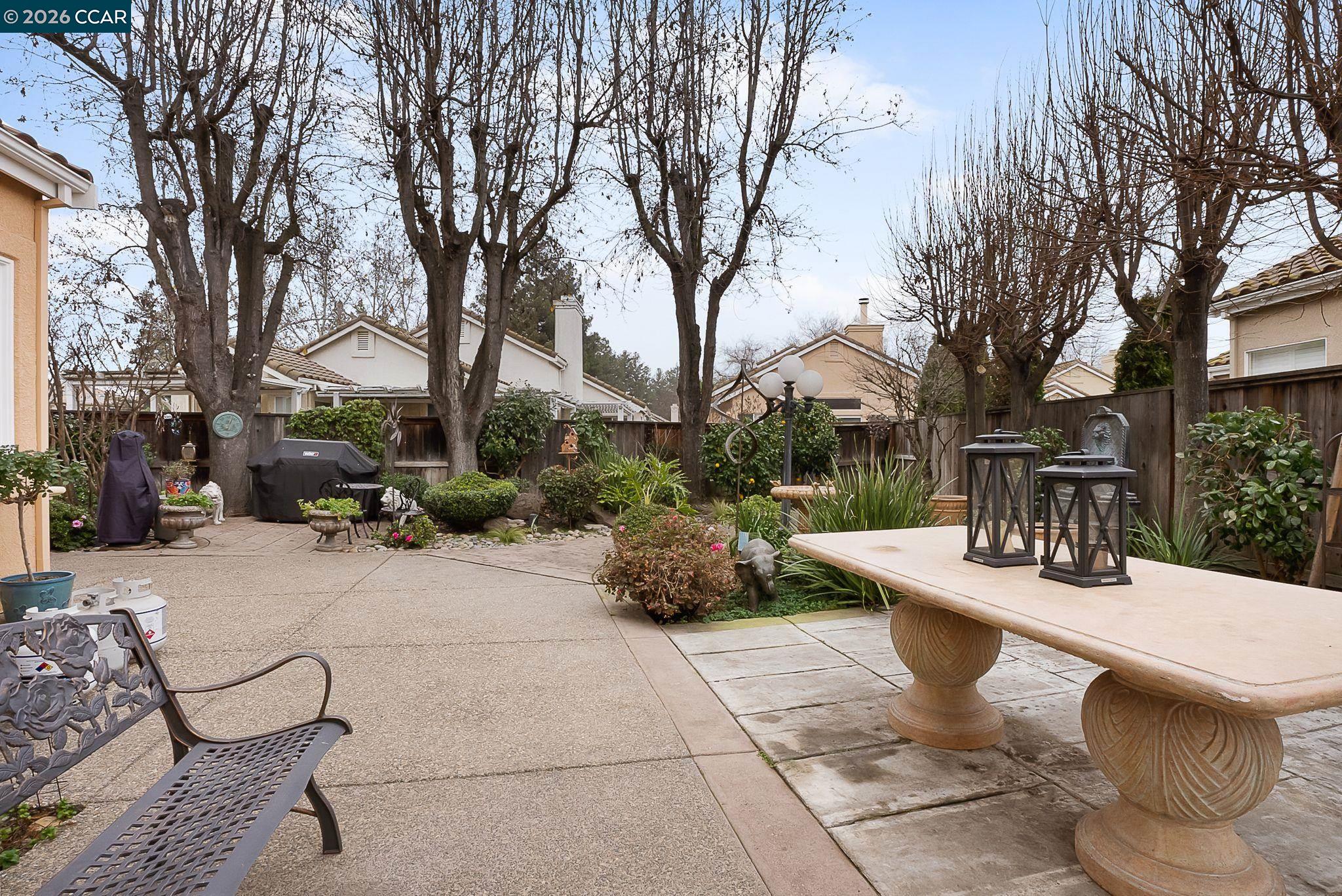 3607 Crystal Tree Court Stockton, CA 95219 - Photo 38 of 44 a view of a patio with couches and table and chairs under an umbrella