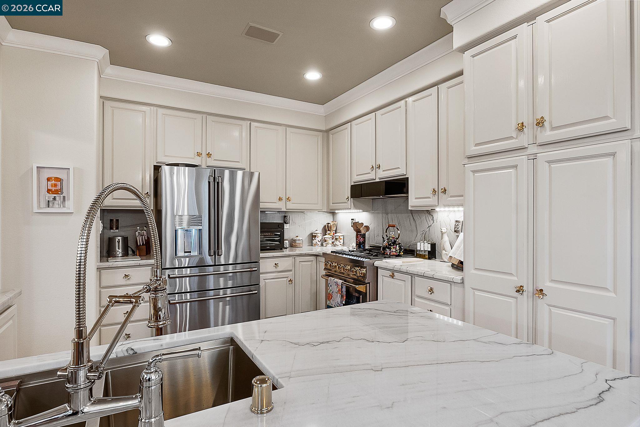 3607 Crystal Tree Court Stockton, CA 95219 - Photo 5 of 44 a kitchen with stainless steel appliances granite countertop a refrigerator sink and stove