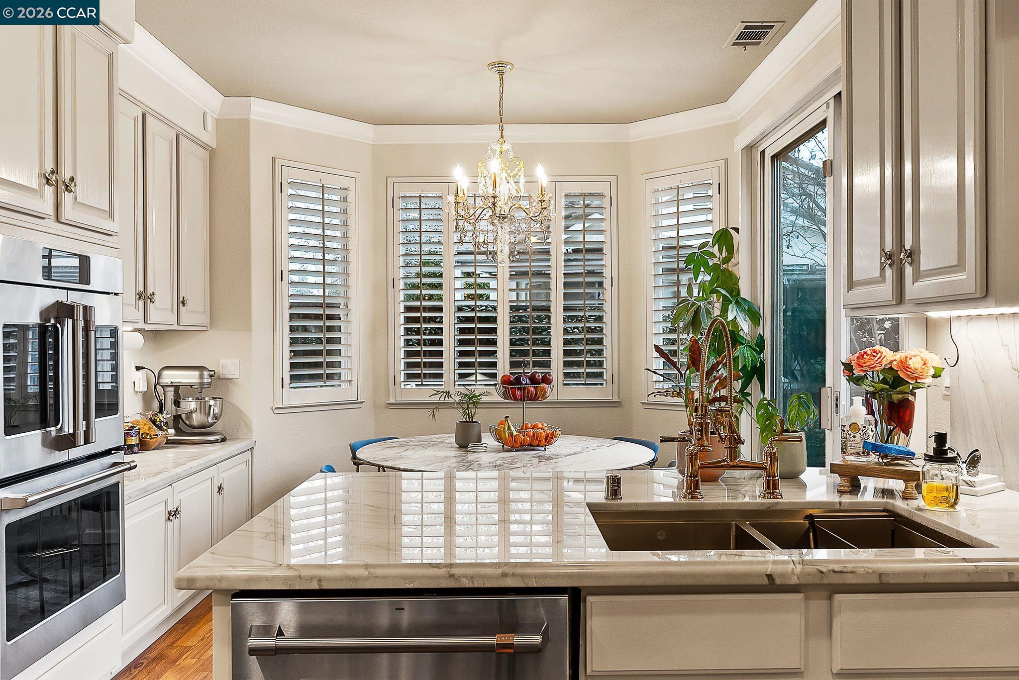 3607 Crystal Tree Court Stockton, CA 95219 - Photo 7 of 44 a view of a kitchen with kitchen island a large window cabinets and stainless steel appliances