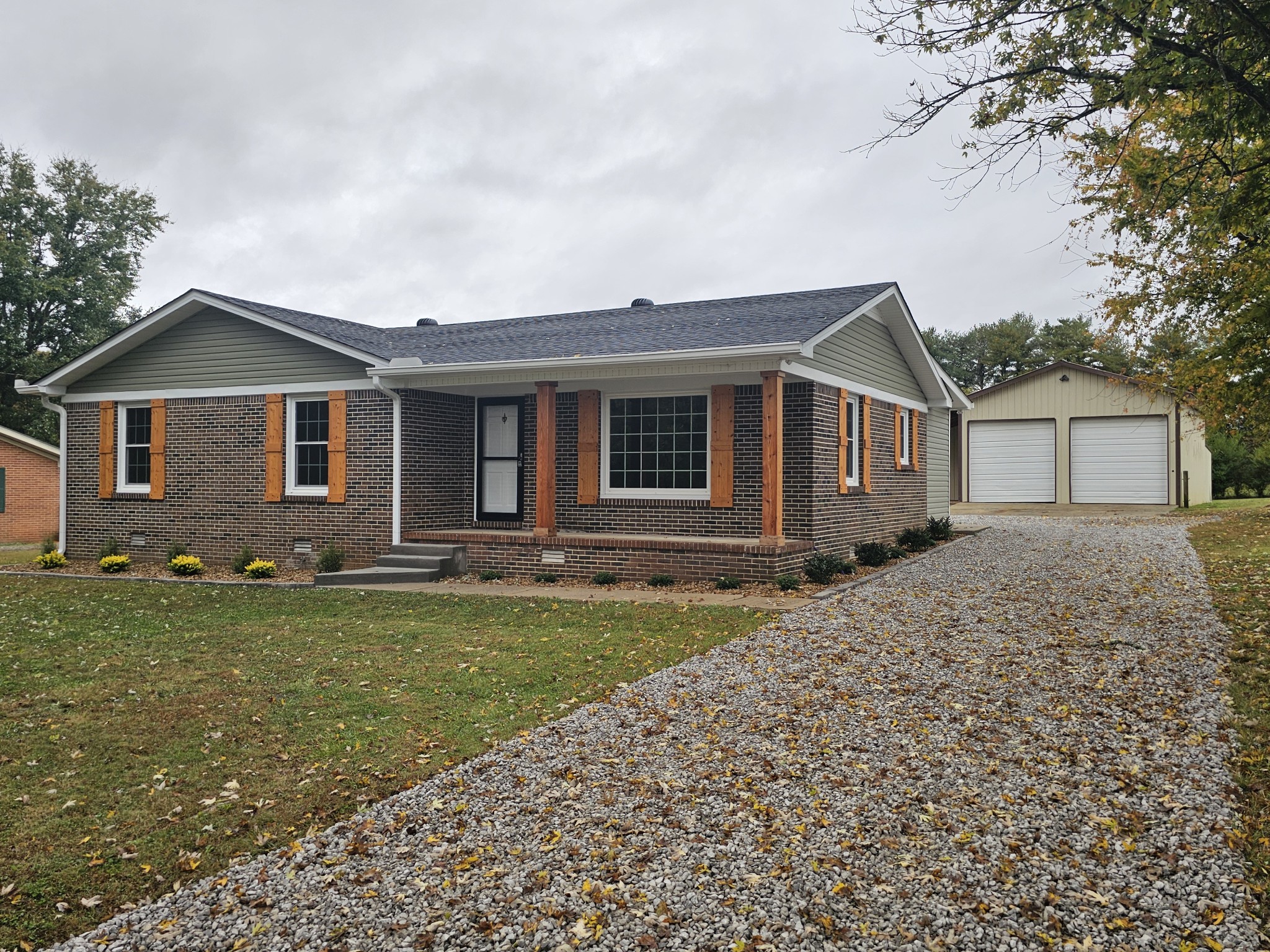 742 Laws Road McMinnville, TN 37110 - Photo 1 of 25 a front view of a house with a garden