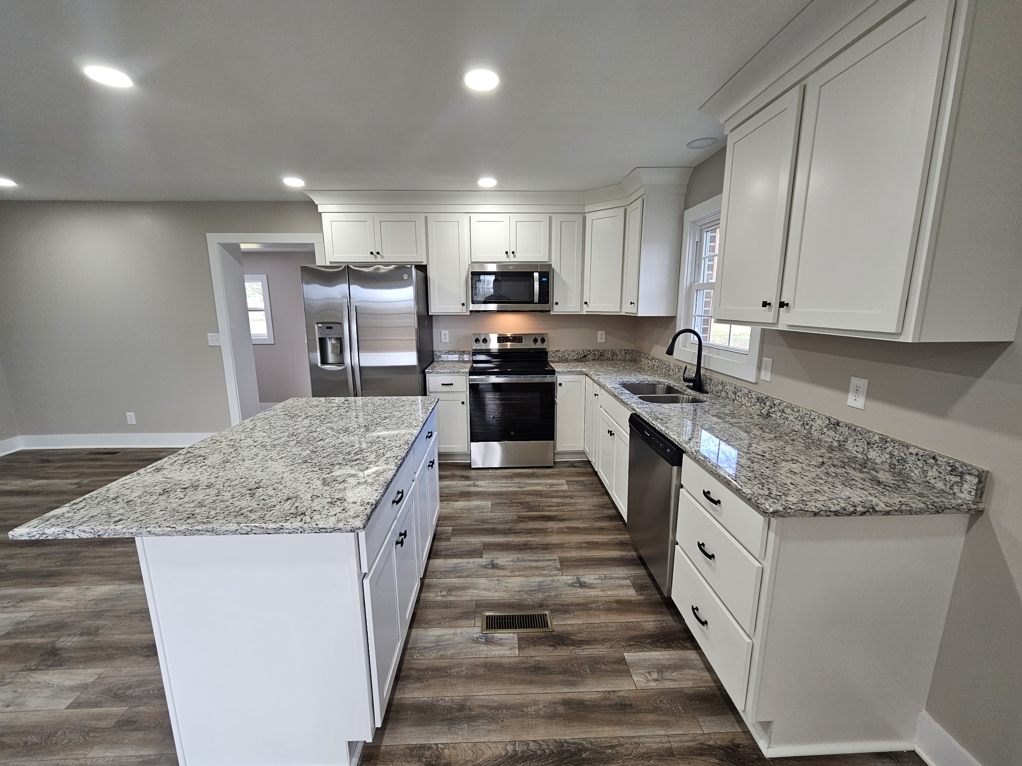 742 Laws Road McMinnville, TN 37110 - Photo 12 of 25 a large kitchen with stainless steel appliances granite countertop a stove top oven a refrigerator a sink and dishwasher