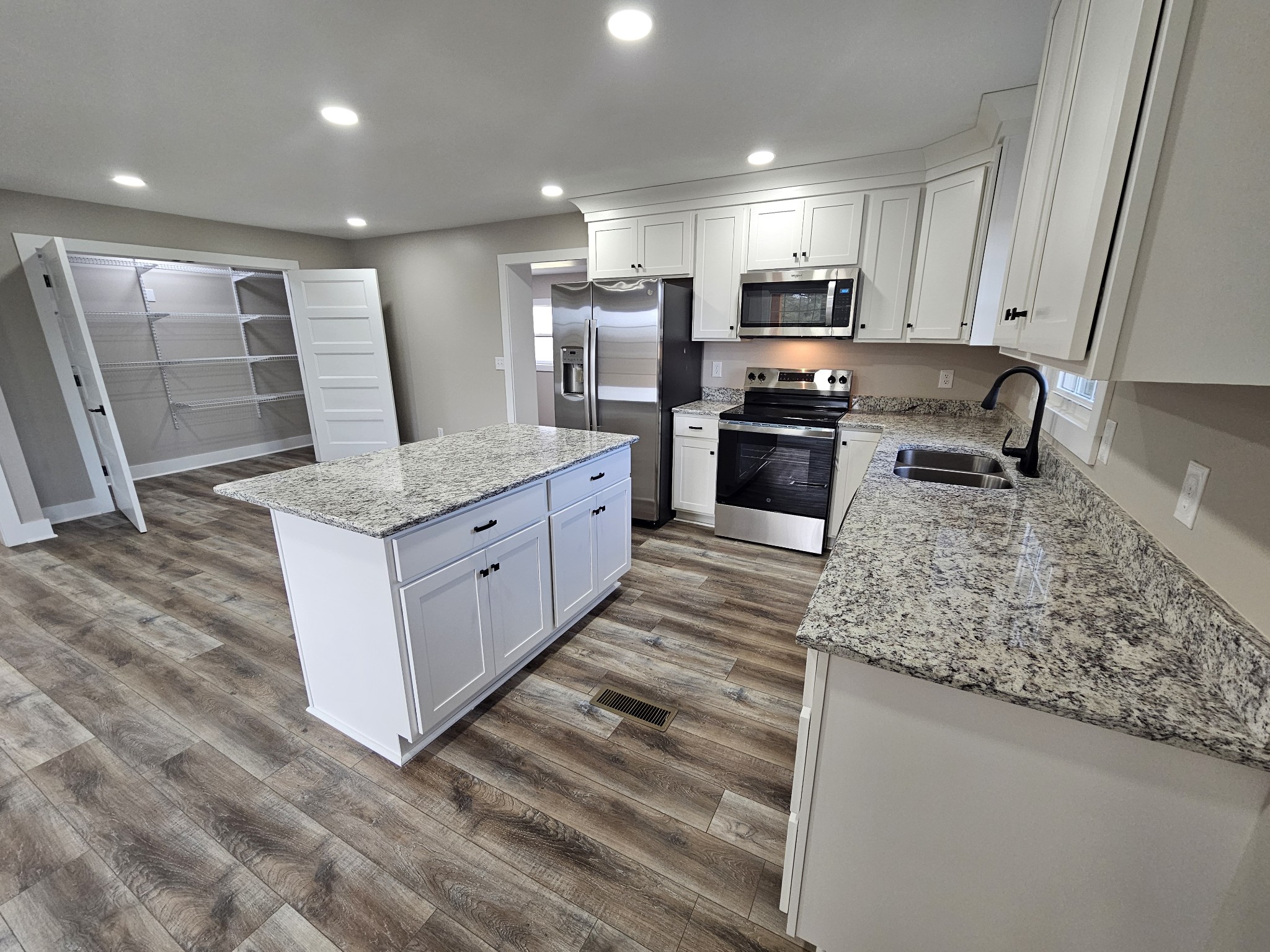 742 Laws Road McMinnville, TN 37110 - Photo 14 of 25 a kitchen with stainless steel appliances granite countertop a sink stove and refrigerator