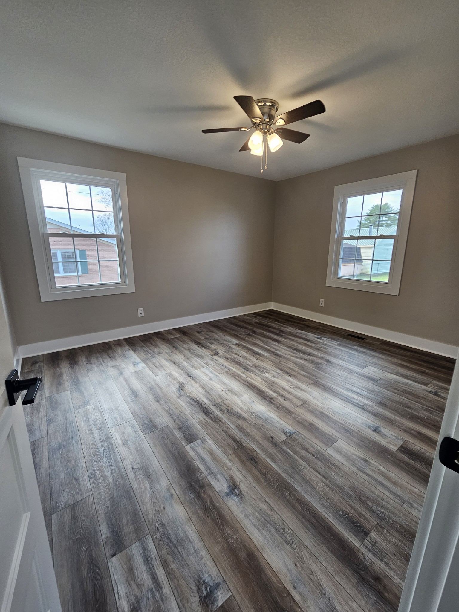 742 Laws Road McMinnville, TN 37110 - Photo 18 of 25 a view of an empty room with wooden floor and a window