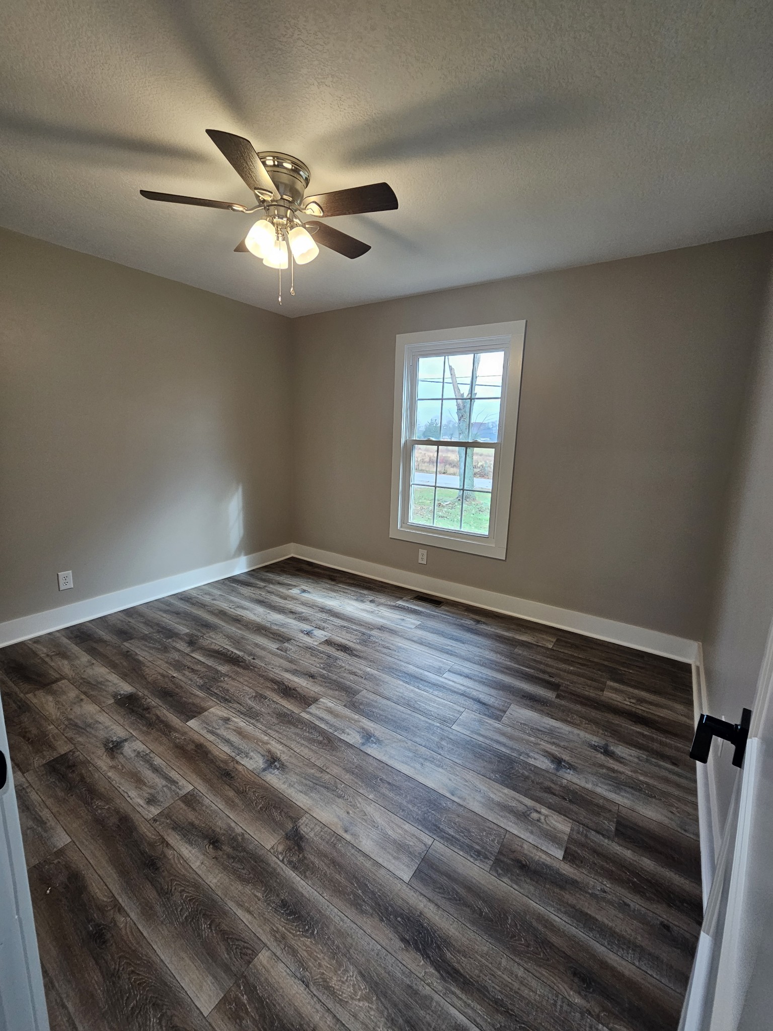 742 Laws Road McMinnville, TN 37110 - Photo 19 of 25 a view of an empty room with wooden floor and a window