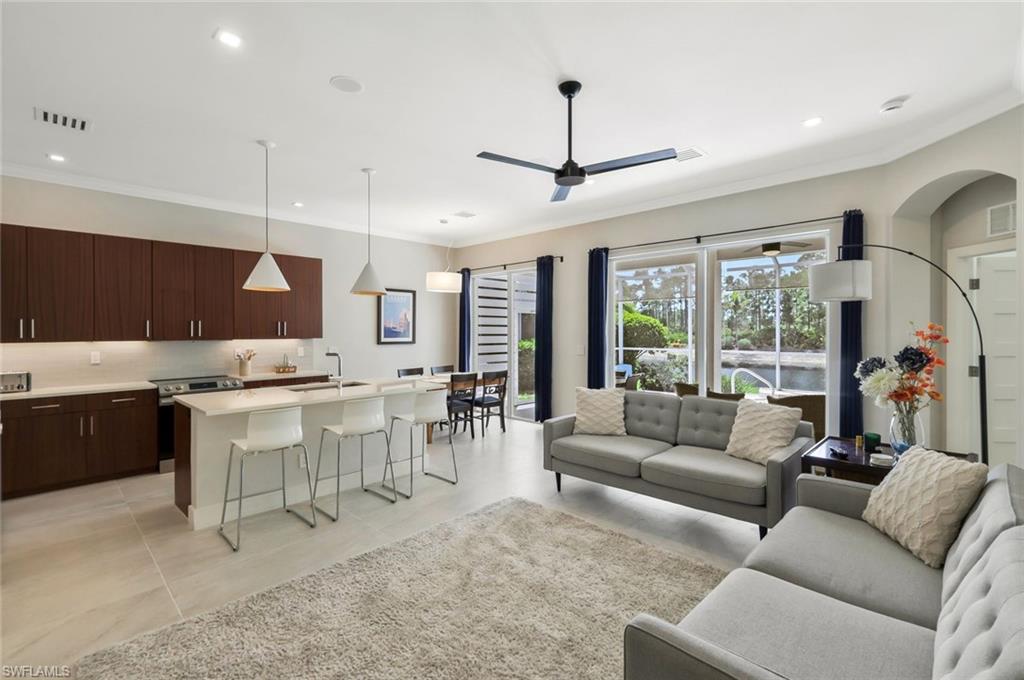5717 Lago Villaggio Way Naples, FL 34104 - Photo 13 of 35 a living room with lots of furniture and view of kitchen
