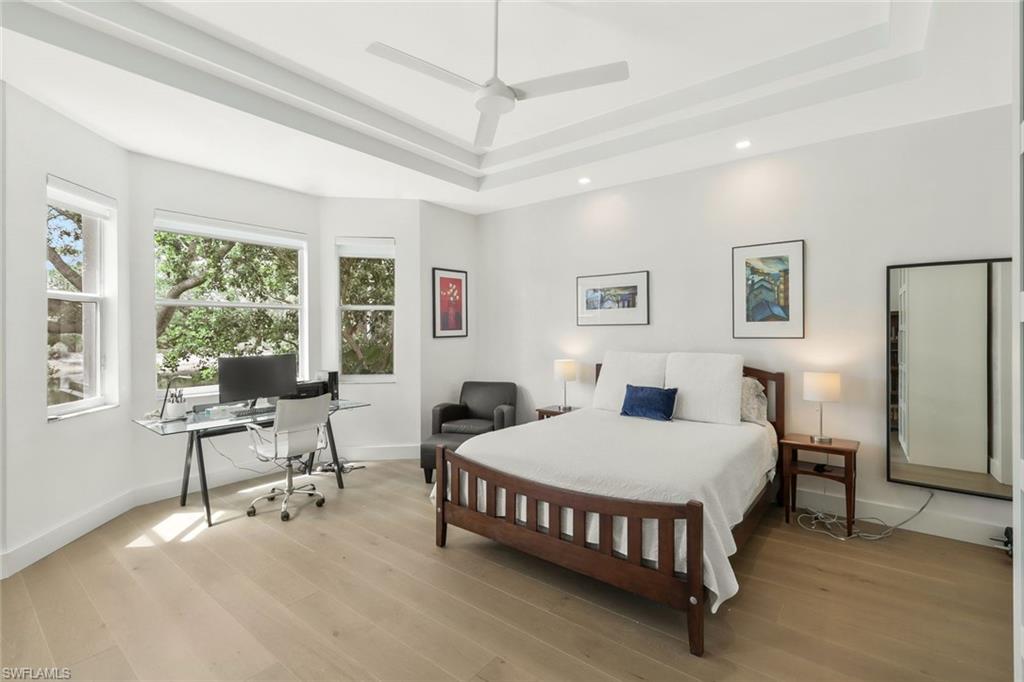 5717 Lago Villaggio Way Naples, FL 34104 - Photo 21 of 35 a bedroom with a bed window and a table in it