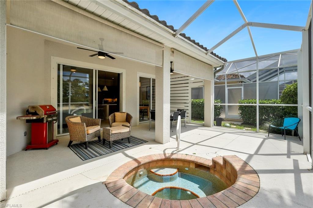 5717 Lago Villaggio Way Naples, FL 34104 - Photo 30 of 35 a outdoor space with patio the couch and glass door