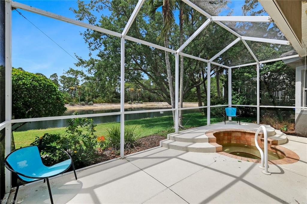 5717 Lago Villaggio Way Naples, FL 34104 - Photo 32 of 35 a view of a swimming pool with a patio and a yard