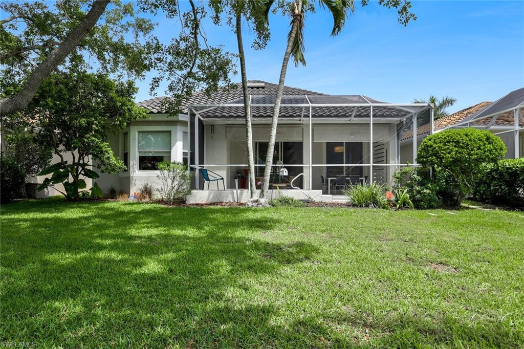5717 Lago Villaggio Way Naples, FL 34104 - Photo 33 of 35 a front view of a house with garden
