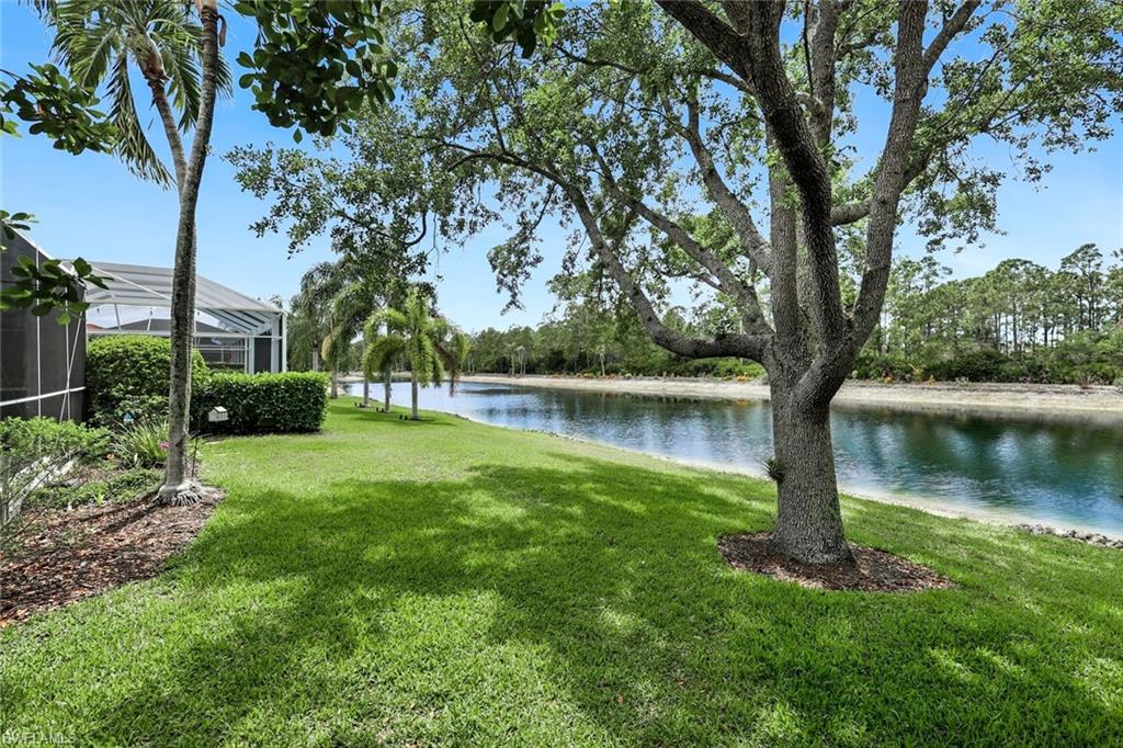5717 Lago Villaggio Way Naples, FL 34104 - Photo 34 of 35 a lake view with a garden