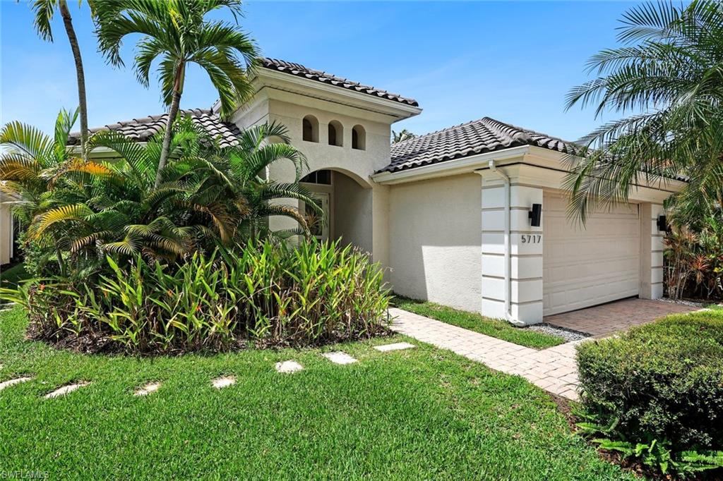 5717 Lago Villaggio Way Naples, FL 34104 - Photo 35 of 35 a front view of a house with a garden