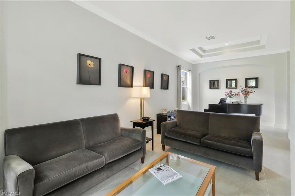 5717 Lago Villaggio Way Naples, FL 34104 - Photo 5 of 35 a living room with furniture and a couch