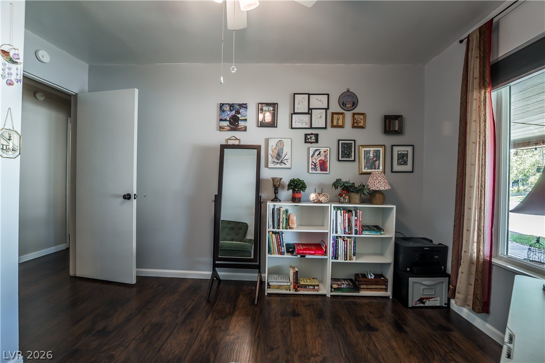 1324 Appaloosa Road Boulder City, NV 89005 - Photo 32 of 42 Rich hardwood-style flooring and a bright window create an inviting atmosphere in this versatile room.