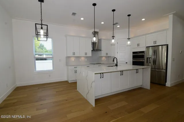 a living room with a bed furniture and a large window