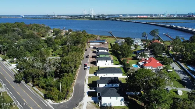 a view of a lake with a large bridge and a bench